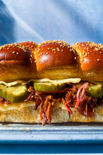 BBQ pulled mushroom sliders made with shredded king oyster mushrooms and melted cheese