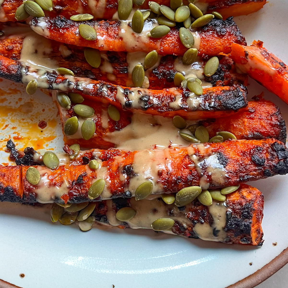 Harissa-Maple Roasted Carrots with Tahini Drizzle