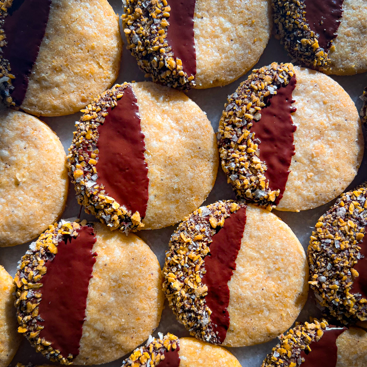 Browned butter cornflake crunch cookies dipped in dark chocolate and coated with flaky salt