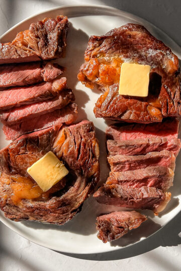 Ribeye steak cooked in the air fryer and sliced medium rare with melted butter