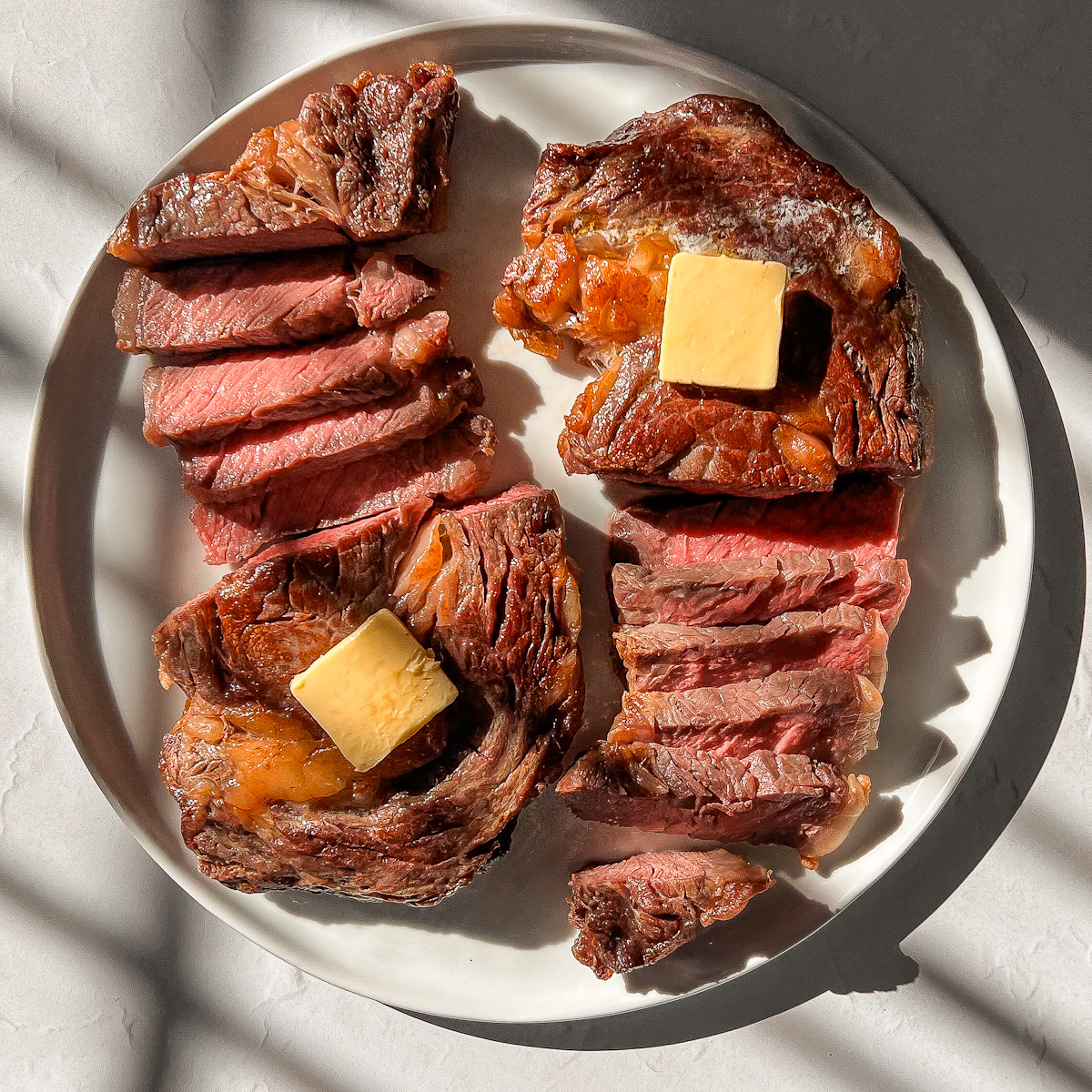 Ribeye steak cooked in the air fryer and sliced medium rare with melted butter