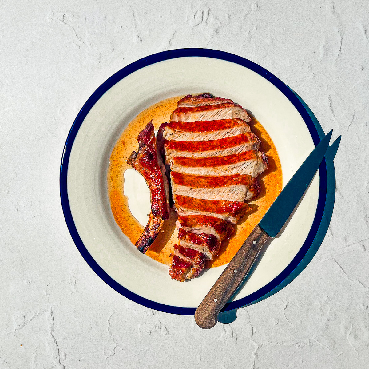 Smoky dry rub pork chops cooked in the air fryer with a caramelized crust