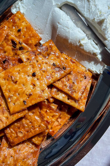 Hot honey saltines and whipped goat cheese on a silver platter