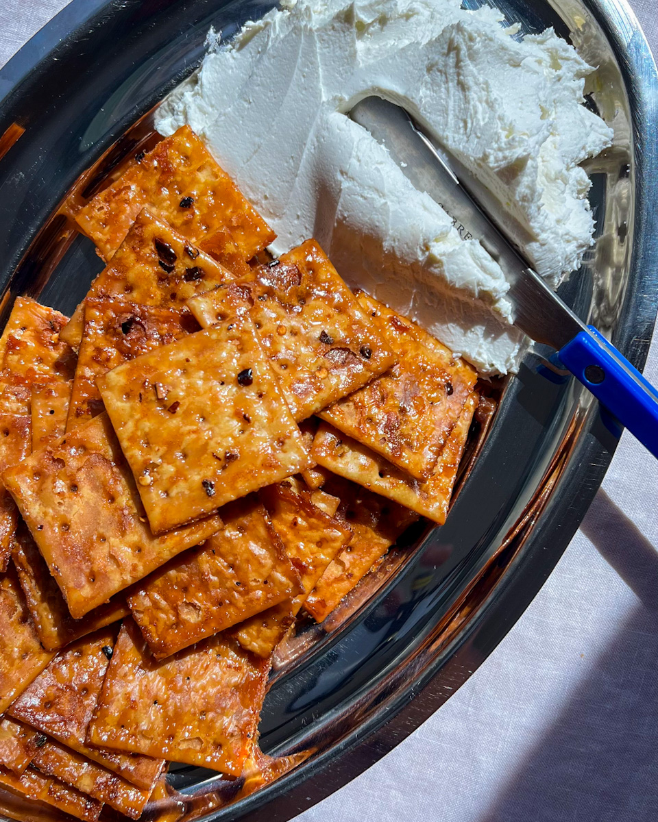 Hot honey saltines with whipped goat cheese served on a platter