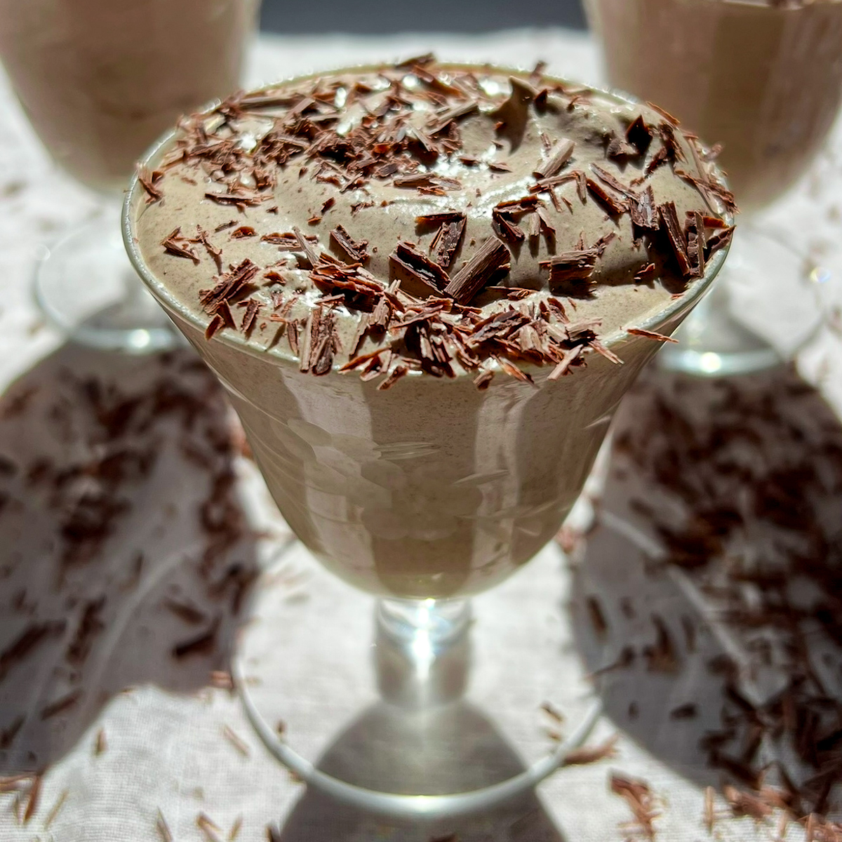 Easy mocha mousse topped with shaved chocolate in a glass