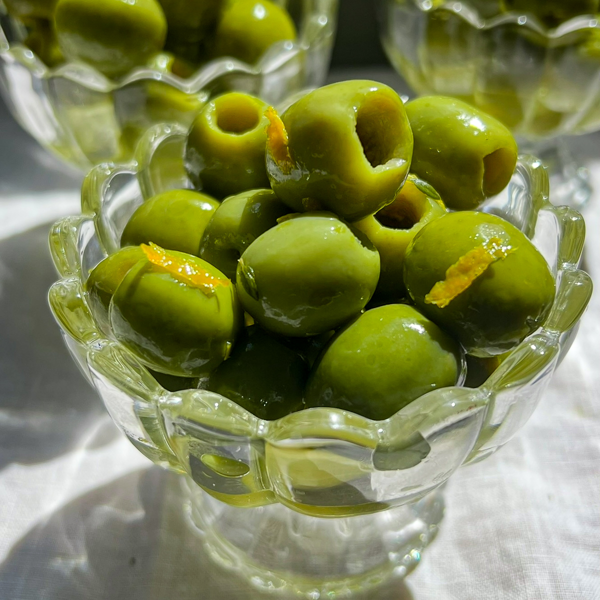 Citrus marinated Castelvetrano olives with orange zest, lemon zest, thyme, and olive oil