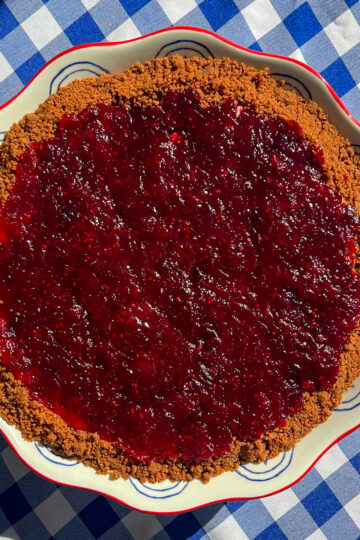 Cranberry pudding pie with layered vanilla pudding and tart cranberry topping on a Biscoff crust