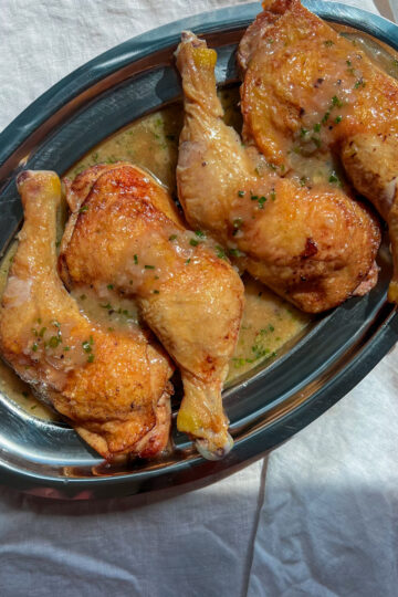 Crispy chicken legs served with a glossy shallot vinegar pan sauce and chives