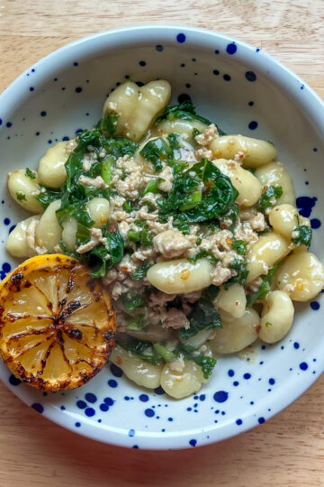 Lemon Chicken Gnocchi in a blue speckled bowl